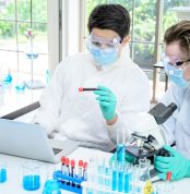 Couple,Male,Scientist,Wearing,Protection,Suit,Working,With,Many,Lab
