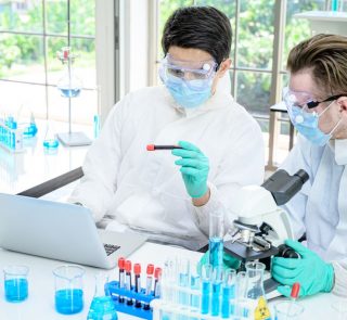 Couple,Male,Scientist,Wearing,Protection,Suit,Working,With,Many,Lab